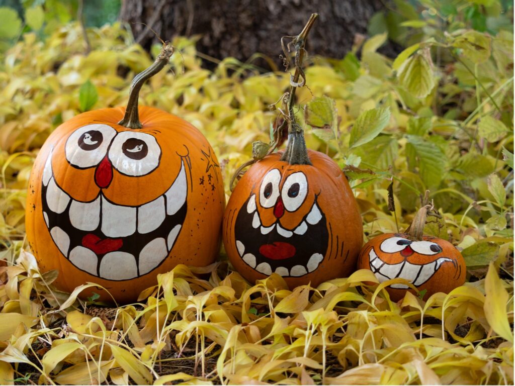 Image containing three pumpkins with face paintings