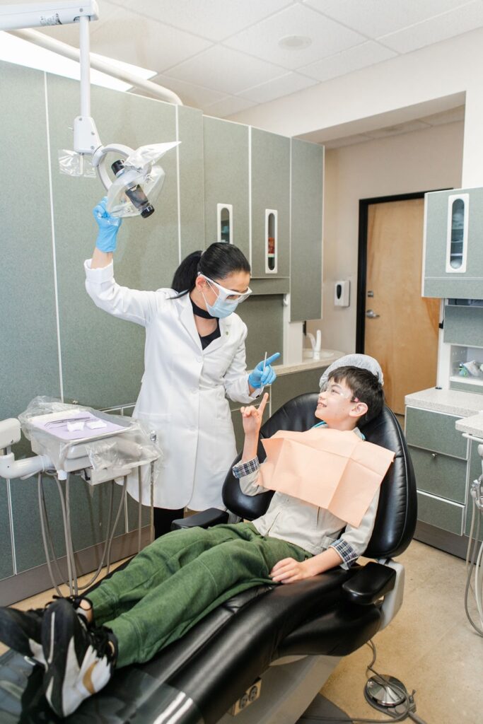 A dentist, Dr. Yamaguchi, with a child in a chair, Routine Dental Exams and Cleanings with Holistic Dentistry